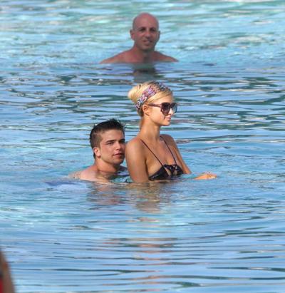 10P Paris Hilton showing off her hot body in skimpy multi colored swimsuit at a pool