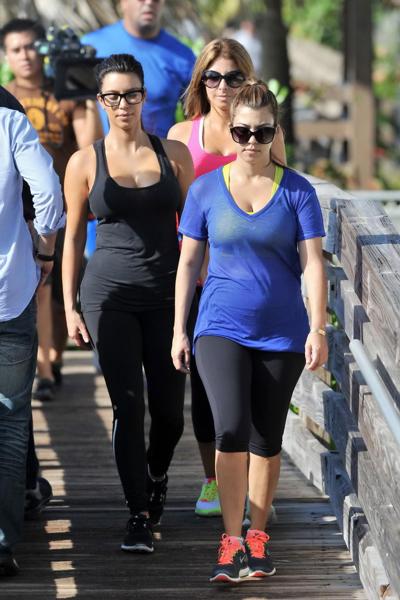 10P Kim Kardashian showing her huge boobs in tight see-through top and tights while 