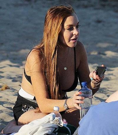 9P Lindsay Lohan exposing huge boobs in bikini top on beach
