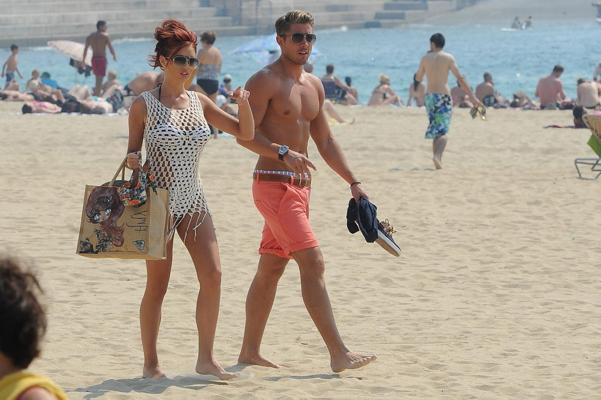 10P Busty babe Amy Chillds showing off her famos curves in skimpy swimsuit at the be