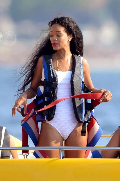 11P Rihanna in sexy white swimsuit posing on a boat in Cannes