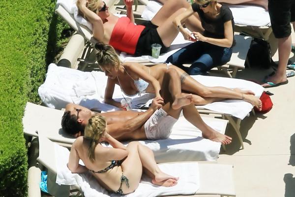 10P Busty babe Katie Price jerking a cock over shorts in public at the pool in Las V