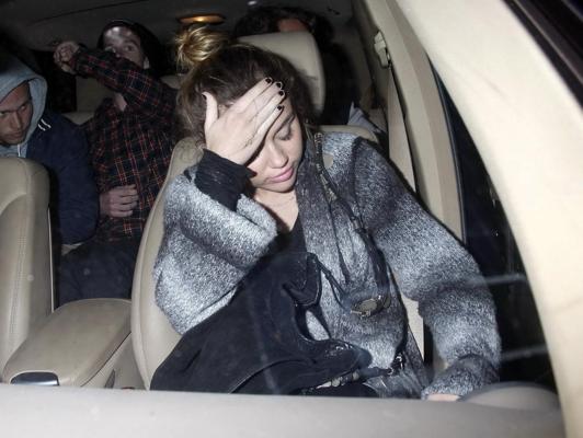 16P Miley Cyrus braless wearing black see through top outside a restaurant