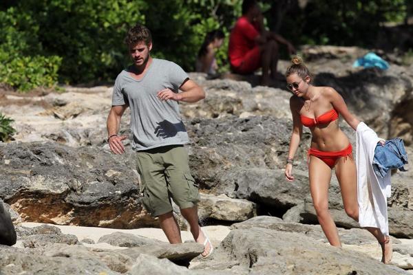 16P Miley Cyrus wearing sexy orange bikini on a Hawaiian beach
