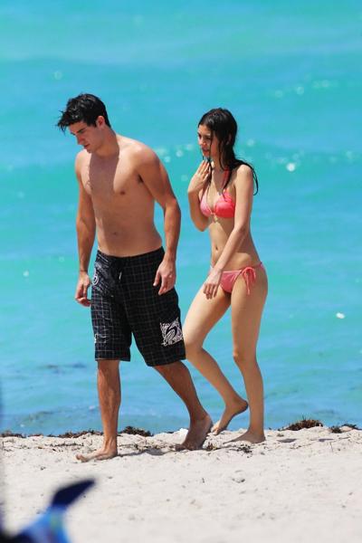 16P Victoria Justice shows cameltoe wearing wet bikini on a beach in Florida