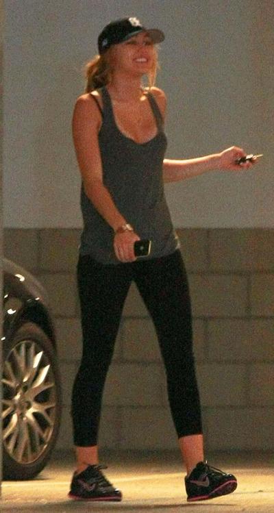 16P Miley Cyrus looking very drunk and showing tattoo under her tits