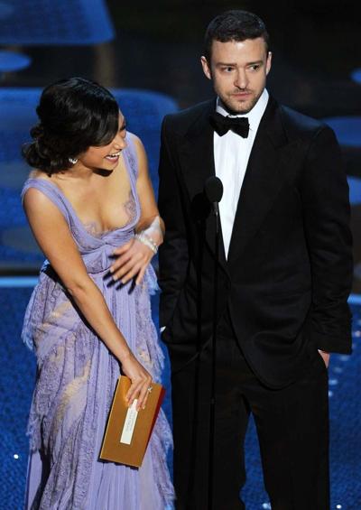 16P Mila Kunis exposing her sexy body and nice cleavage in see thru dress