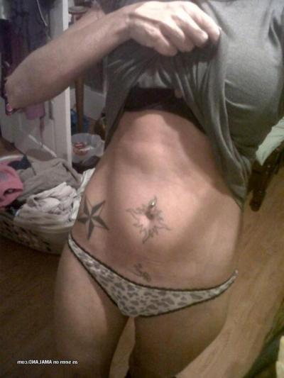 15P Naughty inked MILF flashes her nice trimmed pussy