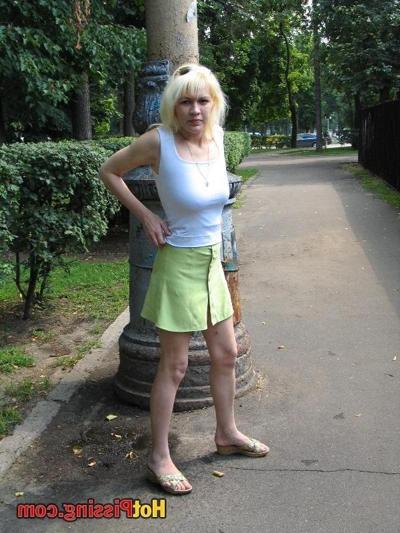10P Outdoor pissing escapade of a slutress in a white top and a green mini