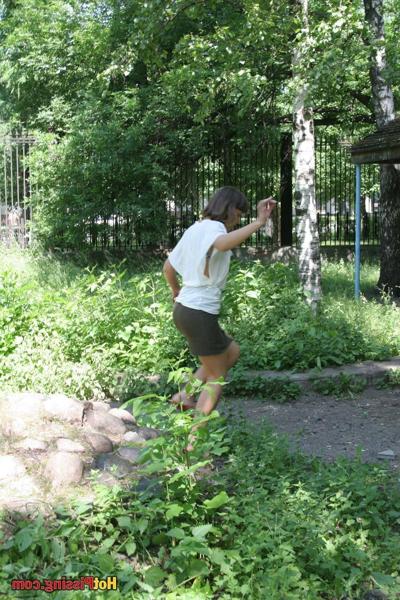 10P Coy babe empties her full bladder while balancing on the public rocks