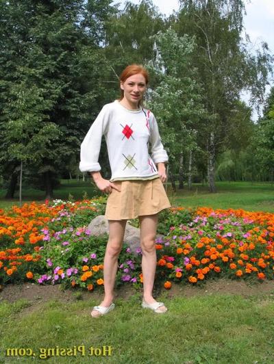 15P Naughty wench squats in the middle of a flowerbed and makes a pee-pee