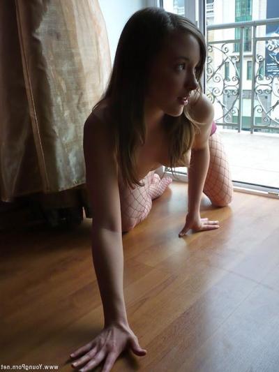 15P Young woman with beautiful breasts strips by window