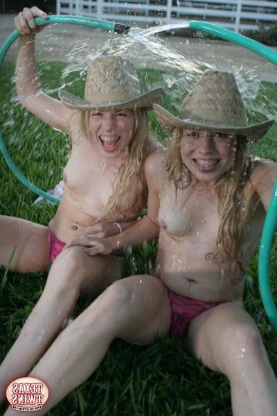 15P Twin eighteen year old sisters hosing each other off outdoors