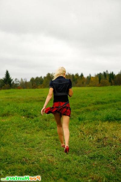 16P Gorgeous busty blonde filmed pissing on a field